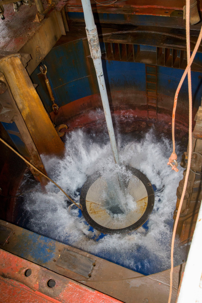 A free-fall funnel is deployed through the ship’s moonpool to aid with reentering Hole U1480G. 