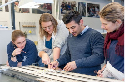 PhD students studying a sediment core