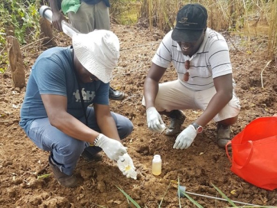 Amon (to the left) filtering river water 