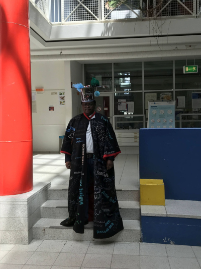 Amon with the doctoral gown and hat
