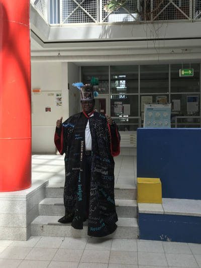 Amon with the doctoral gown and hat