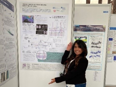 Sofía standing next to her poster