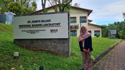 Hana standing in front of the St. John Island Marine Laboratory