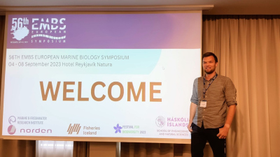 Ronny standing next to a screen giving a presentation