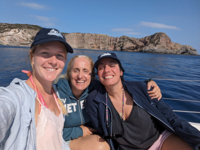 Photo of Eirini, Evi (Paraskevi Nomikou), and Joely on a boat