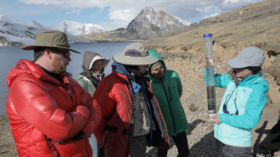 Bronwen Konecky at Washington University in St. Louis (far right) examines a core of lake sediment from Lake Sibinacocha, Peru. Photo: Thomas Malkowicz, Washington University in St. Louis 