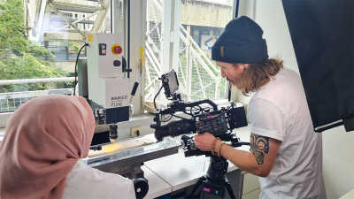 Gemeinsam mit MARUM-Doktorandin Hana Camelia macht ein Kameramann der Agentur Gretchen Video-Aufnahmen von einem Korallen-Bohrkern. Foto: MARUM – Zentrum für Marine Umweltwissenschaften, Universität Bremen, T. Felis