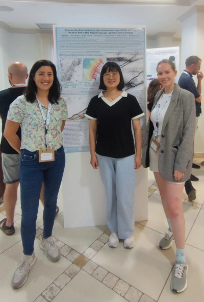 Ling Wang with her group members in front of the poster