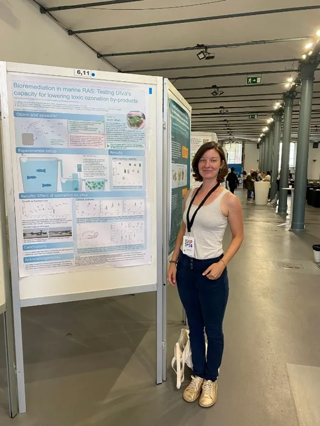 Sabine Weidlich next to her poster