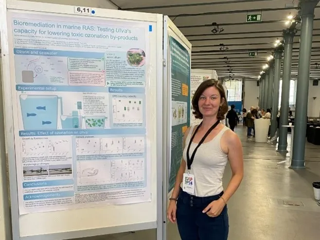 Sabine Weidlich next to her poster