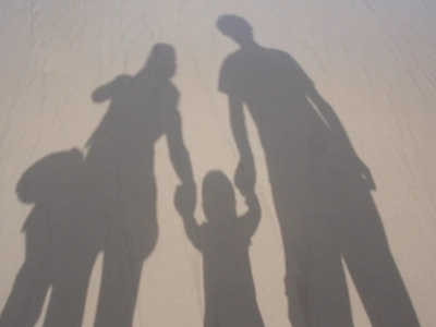 parents with two children, seen as shadows on the ground