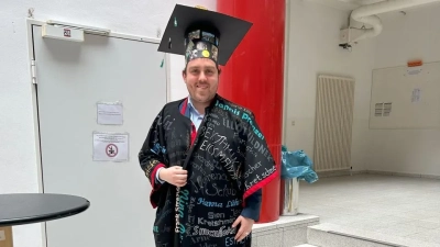 Andrés Daniel Castillo Llarena with his doctoral hat and gown