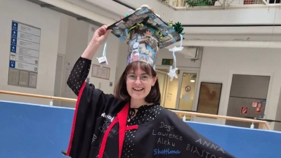 Janinga with her doctoral hat and gown