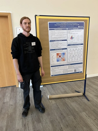 Yannick next to his poster