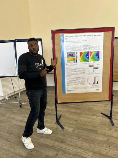 Eugene next to his poster