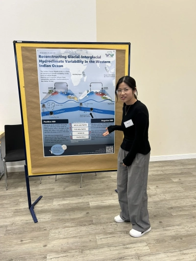 Anran next to her poster
