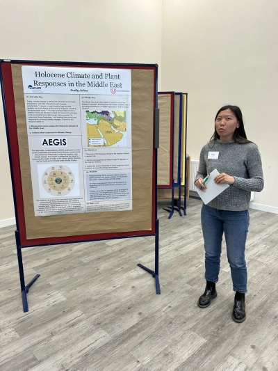 Emily next to her poster