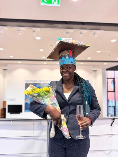 Nancy with her doctoral hat and a bouquet of flowers