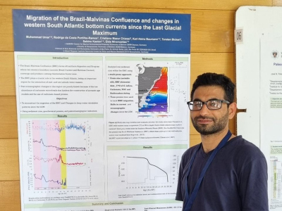 Muhammad Umar next to his poster