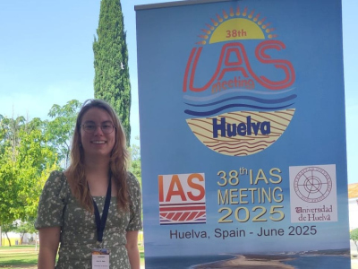 Anna Katharina Baltz next to the confernce sign of the 38th IAS meeting