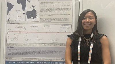 Emily Johns next to her poster